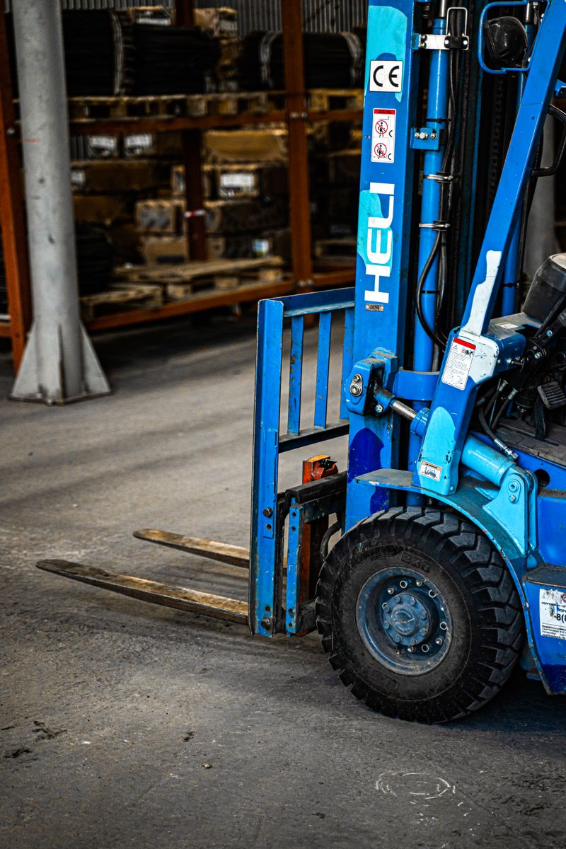 Blue forklift inside an industrial warehouse