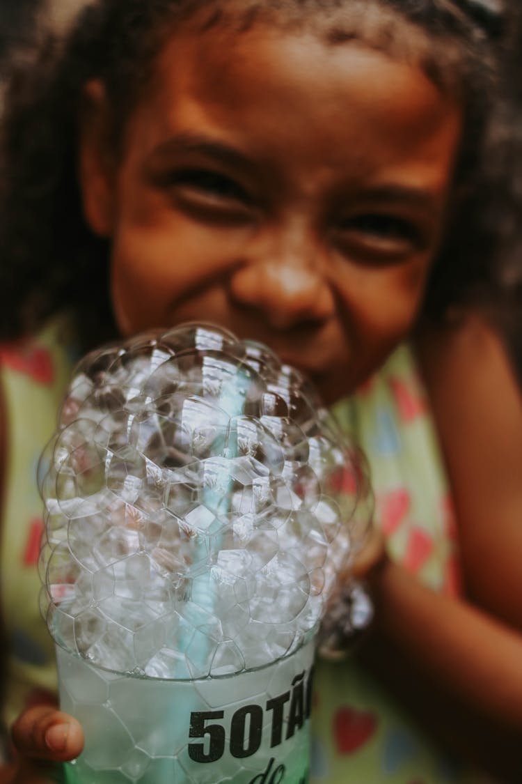 Child Holding Glass With Bubbles