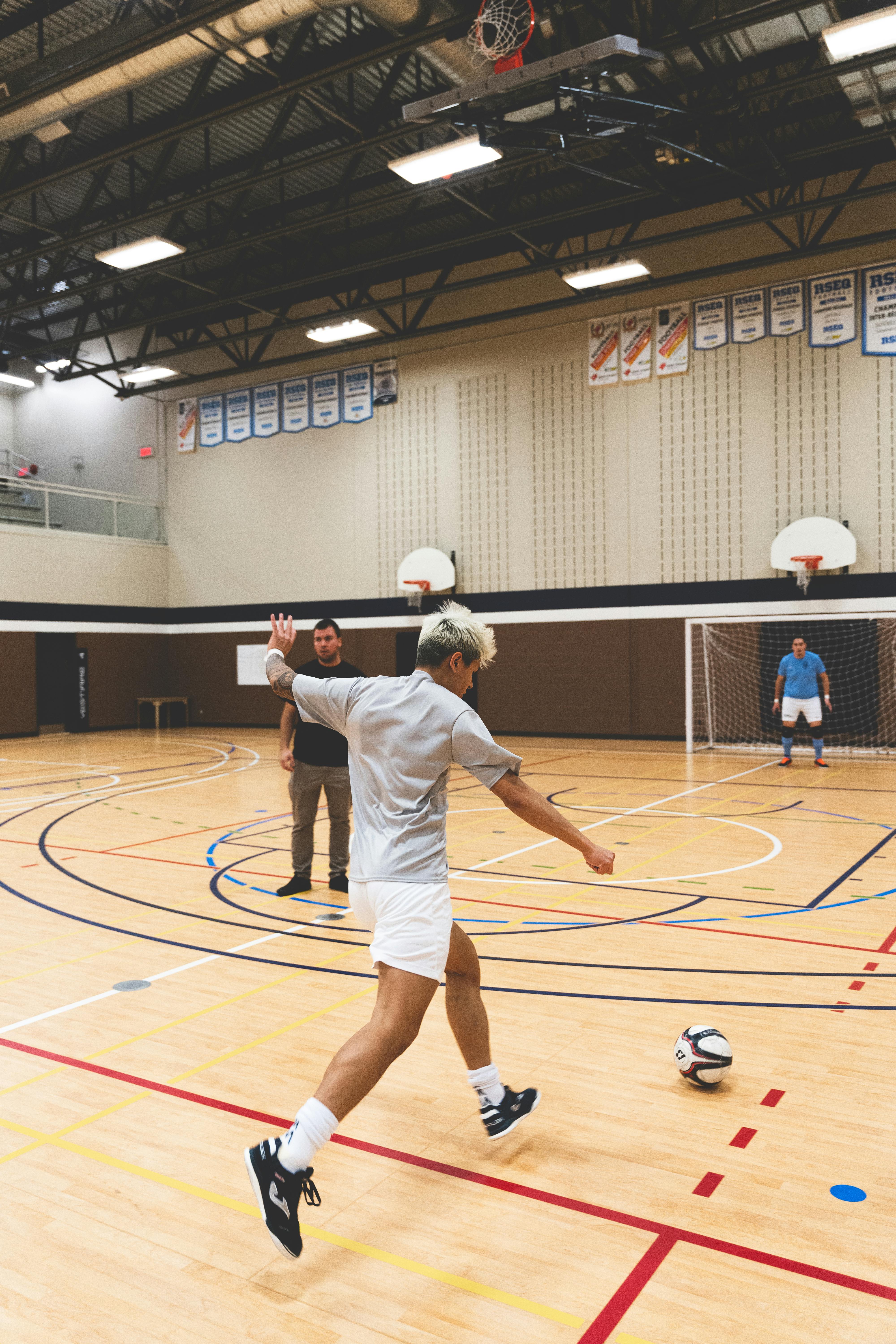 man playing football on a sport hall