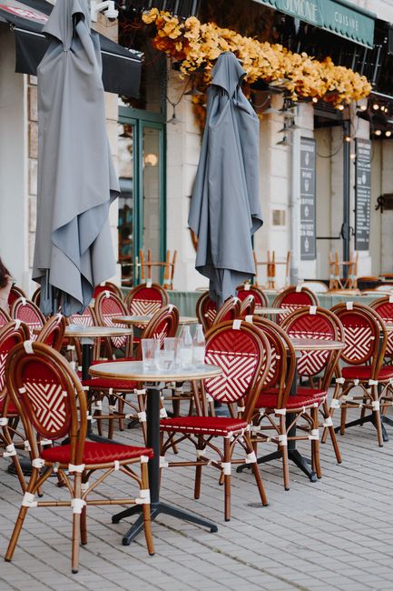 Cozy outdoor cafe setting with classic French decor, perfect for relaxed city dining.