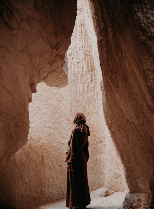 A Woman Standing in a Cave