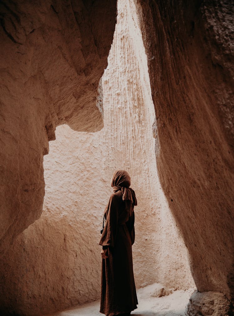 A Woman Standing In A Cave