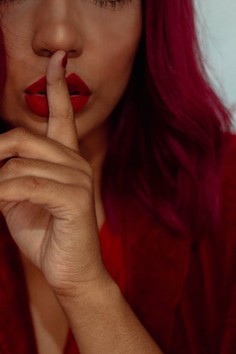 Close-up Of A Person With Finger On Her Lips