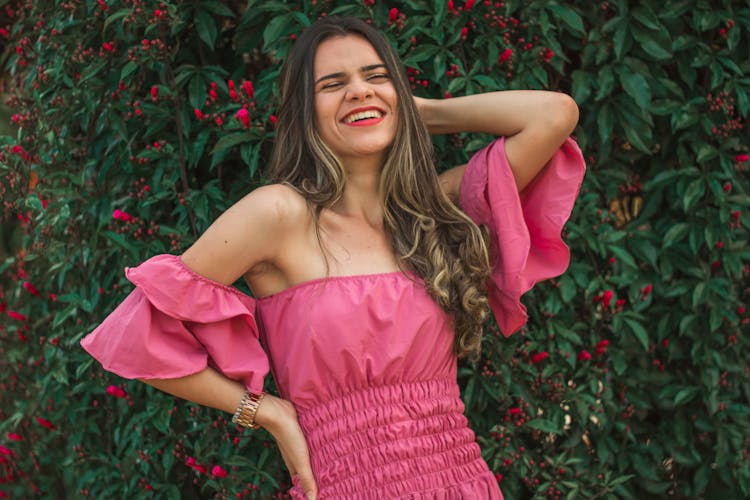 Beautiful Woman In A Pink Dress Laughing 