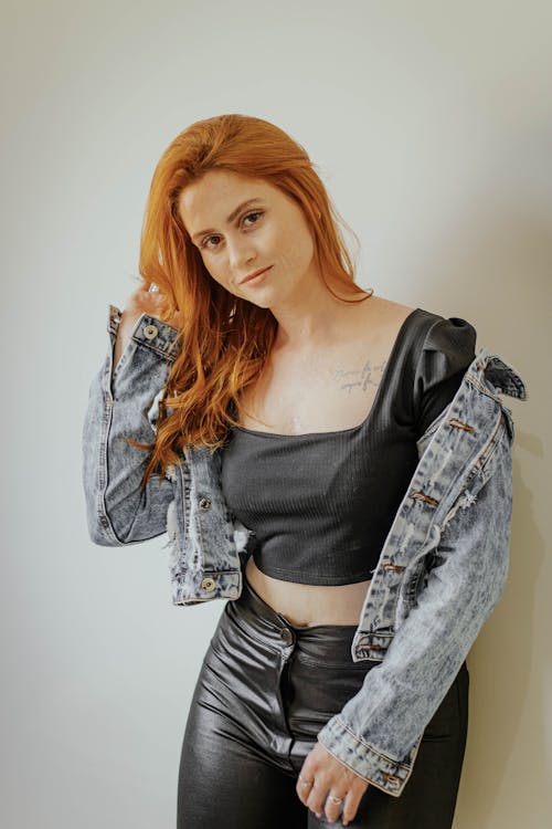 Redhead Woman in Leather Pants and Denim Jacket