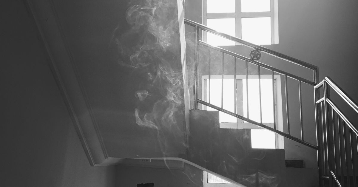 Smoking Railing Silhouette of a Man Smoking while Leaning on a Metal Railing · Free ...
