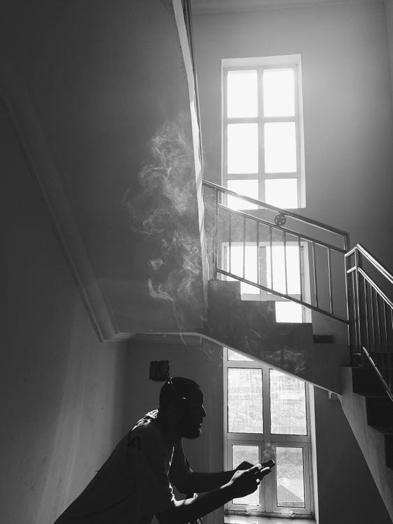 Smoking Railing Silhouette of a Man Smoking while Leaning on a Metal Railing · Free ...