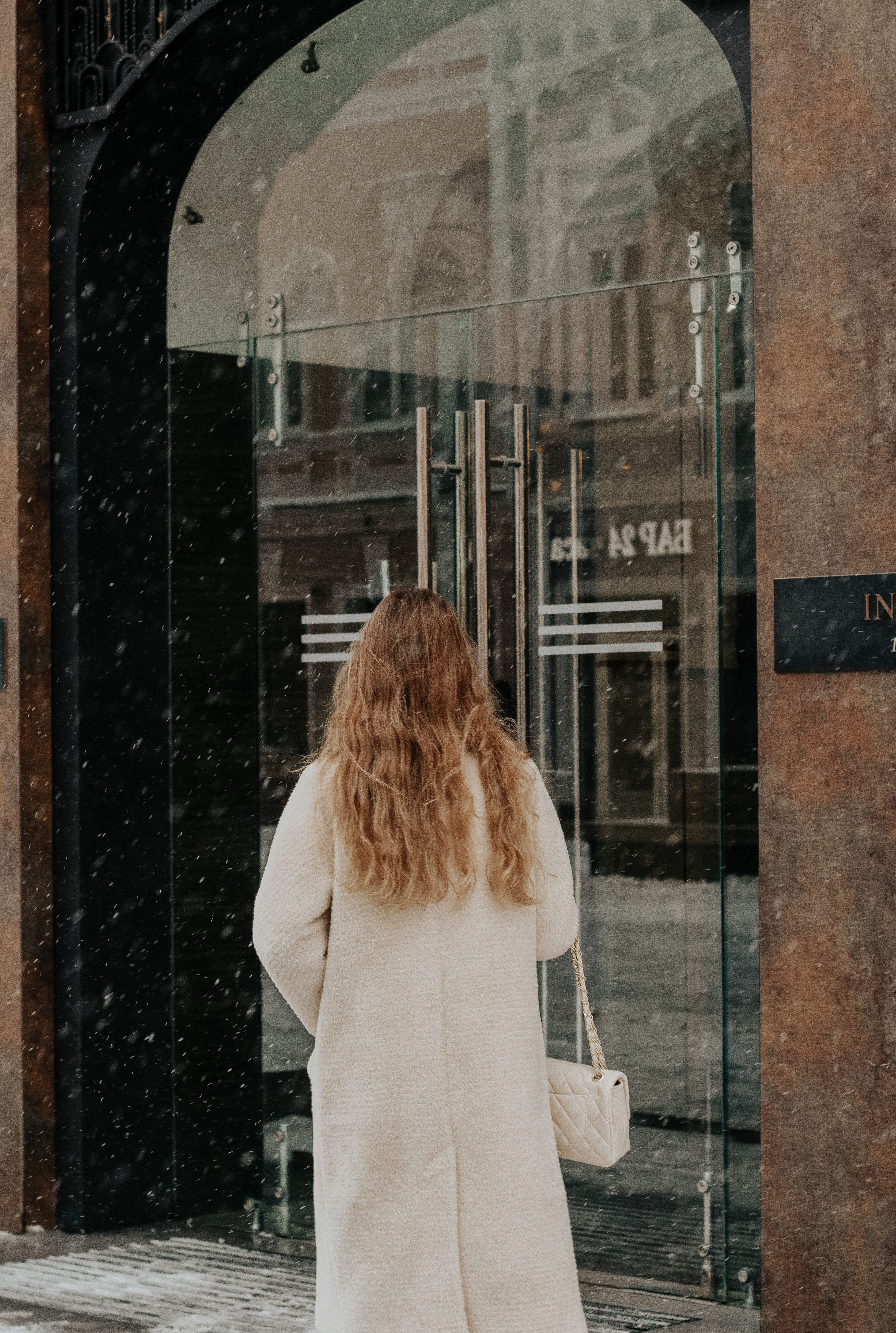 Woman in a White Trench Coat in front of a Glass Door Building · Free ...