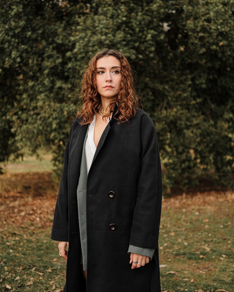 Woman In Coat In Park