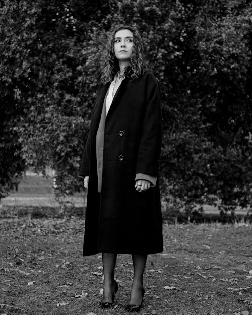 Black and White Photo of a Woman in a Trench Coat