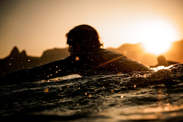 Men Swimming In Sea