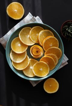 A vibrant display of sliced oranges in a circular pattern on a plate creates an artistic and fresh look.