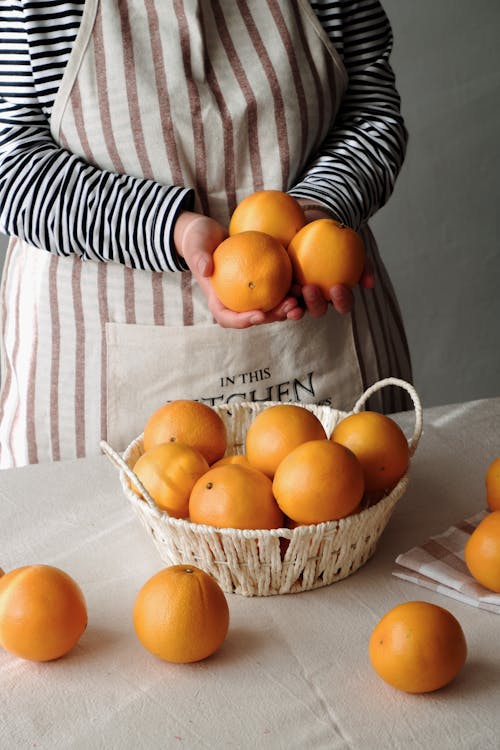 Woman with Oranges on Table