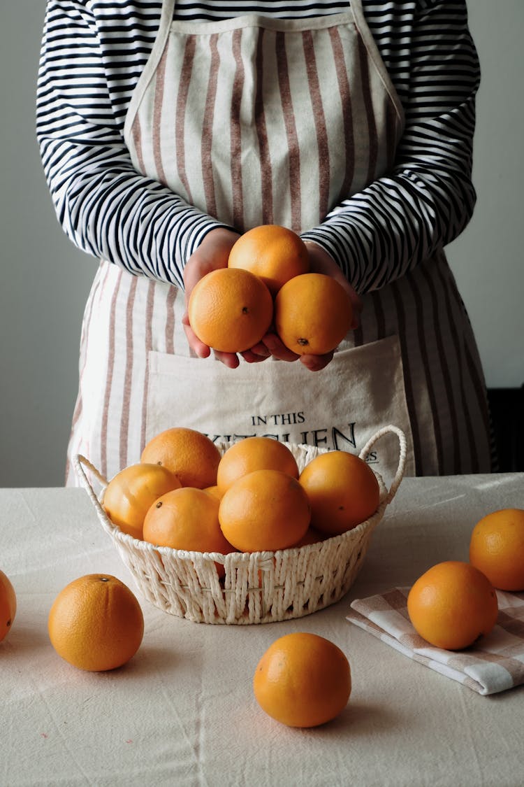 Woman Holding Oranges