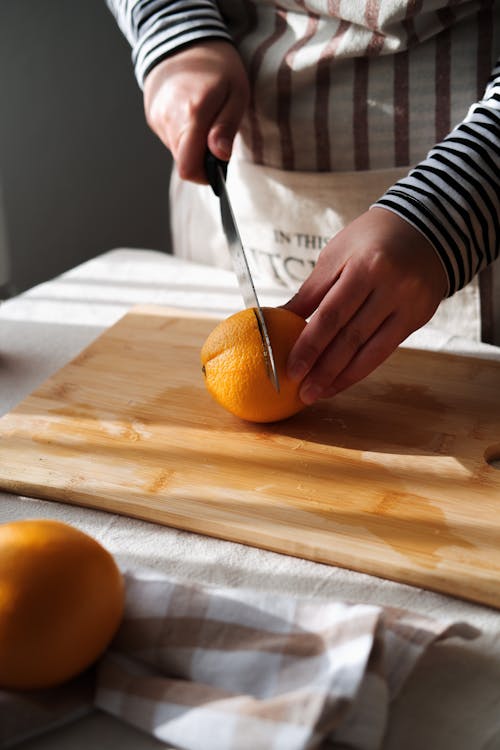 Woman Cutting Orange