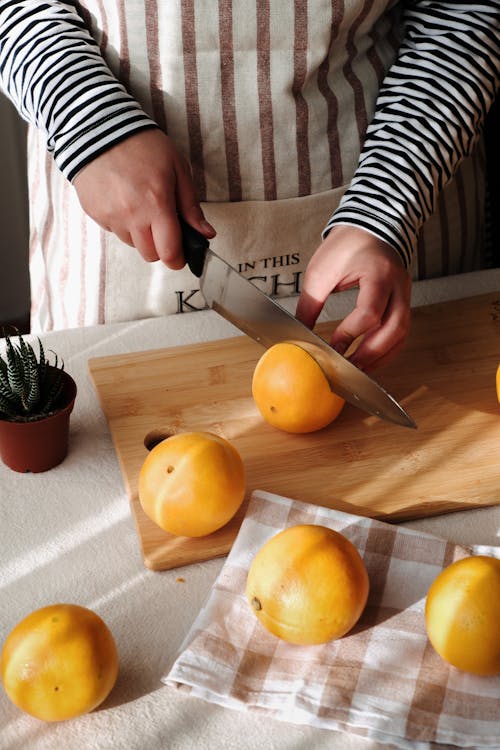 Hands Chopping Grapefruit