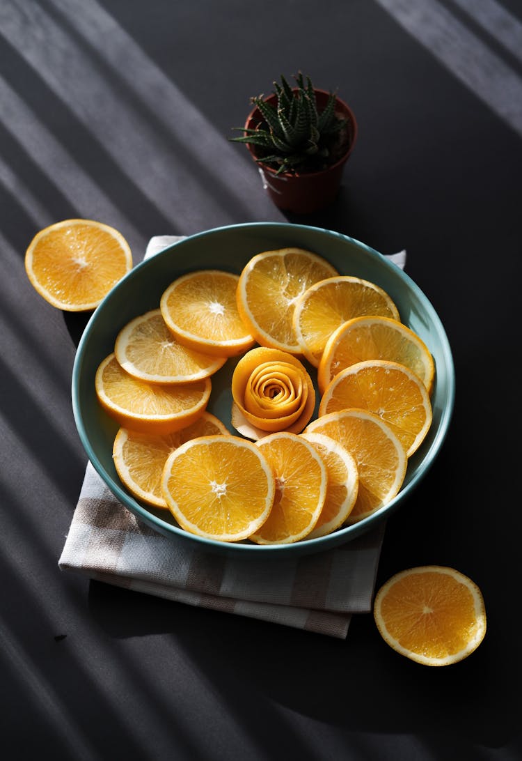 Orange Slices And Plant Near Plate