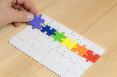 A Person Hoding a Rainbow Color Puzzle