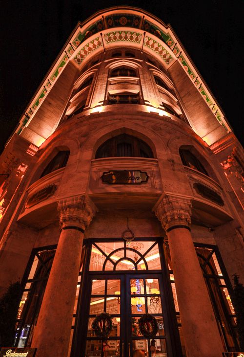 Free Low angle view of a historic building with illuminated facade at night. Stock Photo