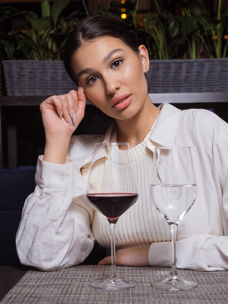 Woman Posing With Glasses Of Wine And Water