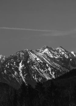 Black and white photo showcasing a snow-covered mountain range in winter.