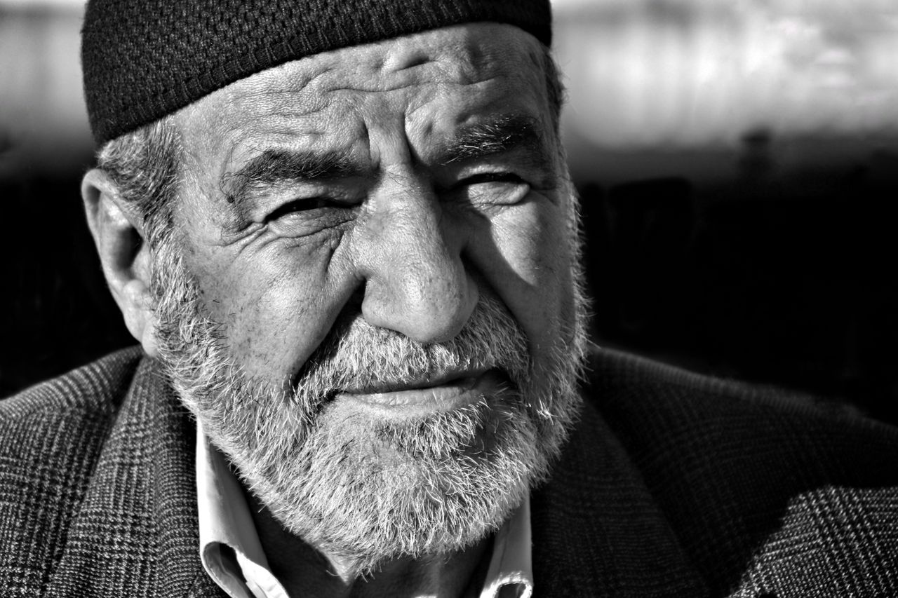 close up portrait of an elderly man in grayscale capturing expressive