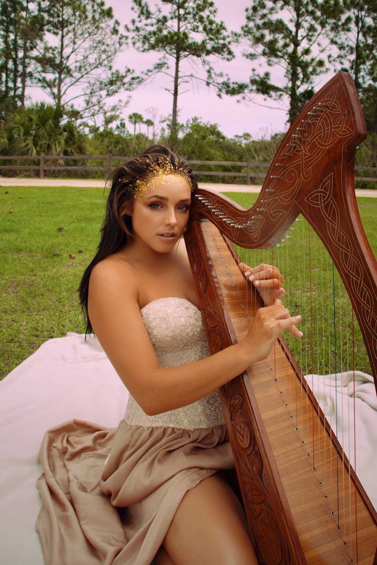 Woman In Dress Playing Harp