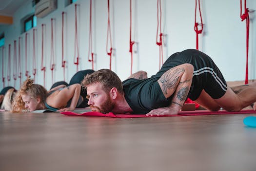 Adults participating in a yoga class, focusing on floor exercises in Rishikesh, India.