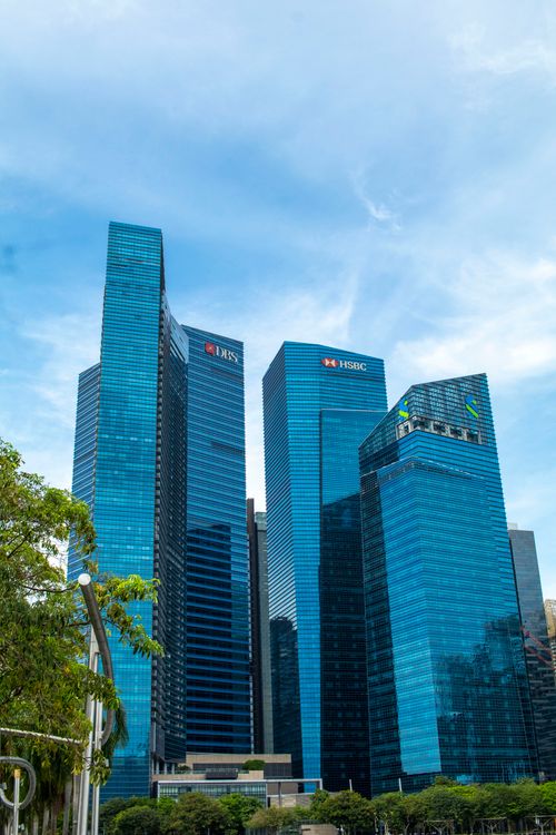 Free Stunning low angle view of iconic skyscrapers in Singapore's financial hub. Stock Photo
