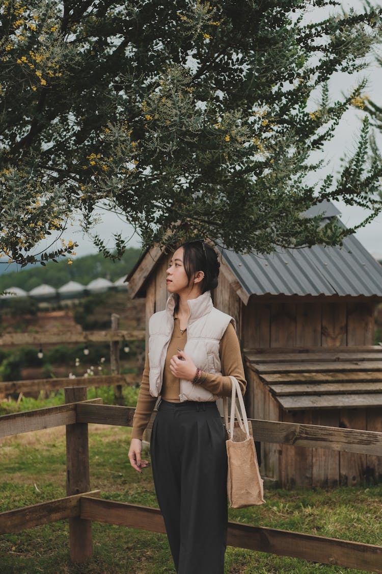 Woman Posing In Pants And Vest In Countryside