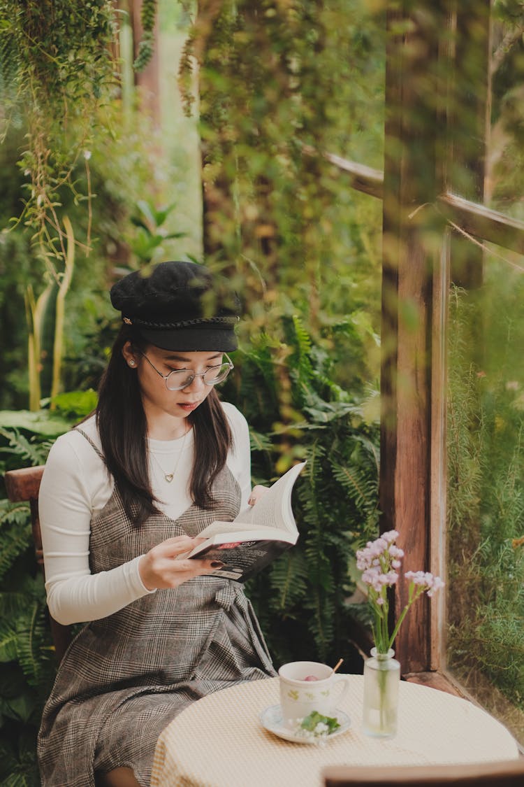 Woman Reading Book In Garden