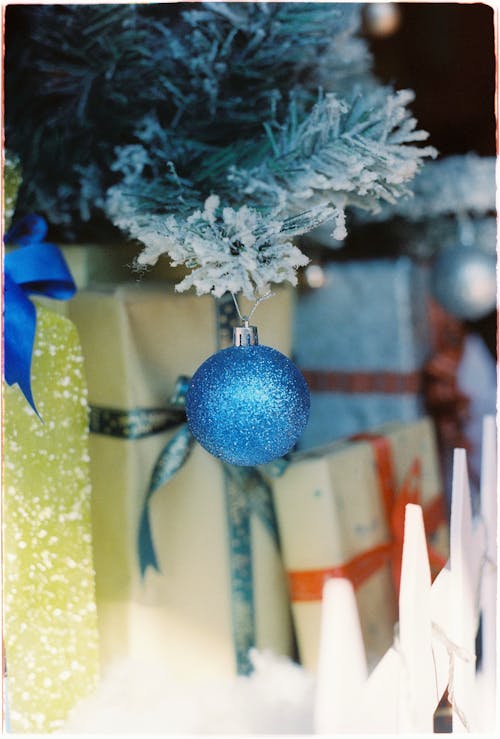 A Blue Christmas Ball Hanging from a Christmas Tree