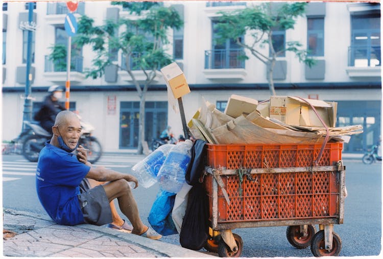 Homeless Man With Cart With Wastepaper