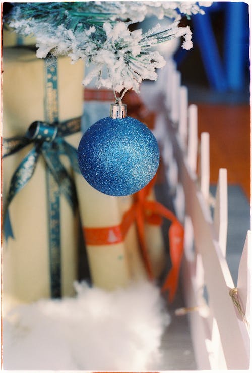 A Blue Christmas Ball Hanging from a Christmas Tree