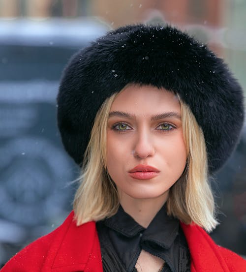 A Beautiful Woman in Winter Cap Looking at the Camera