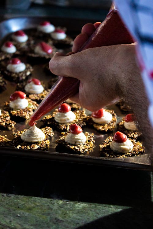 A Person Decorating a Cake