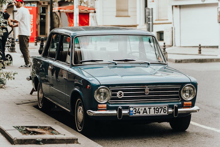 Blue Classic Car Parked On The Road