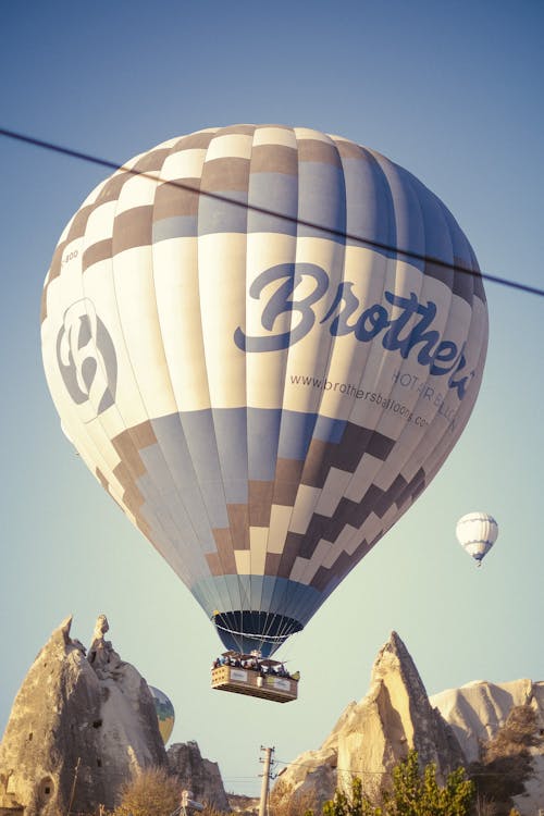 Hot Air Balloon on Mid Air near Rocky Mountains
