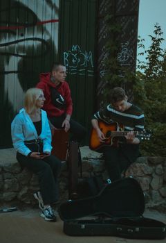 Young musicians playing on a street in Kyiv, Ukraine, creating a lively atmosphere.
