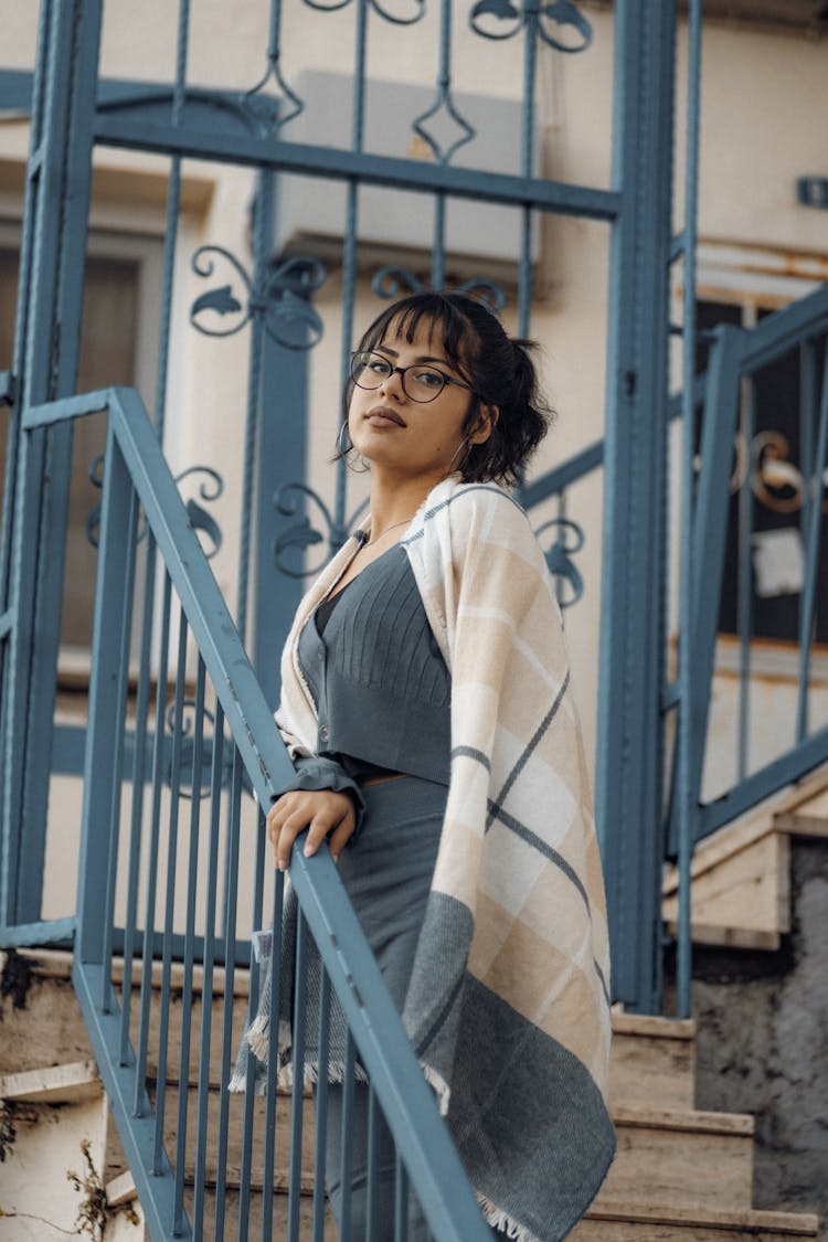 A Woman With A Blanket At The Stairs