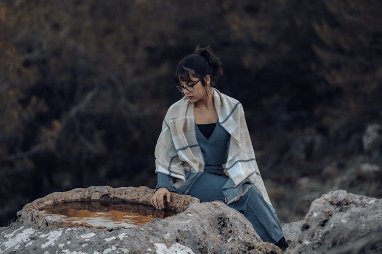 Woman Sitting By Water