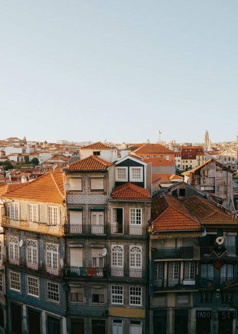 Explore the captivating cityscape of Porto, Portugal, showcasing historic buildings with iconic red roofs.