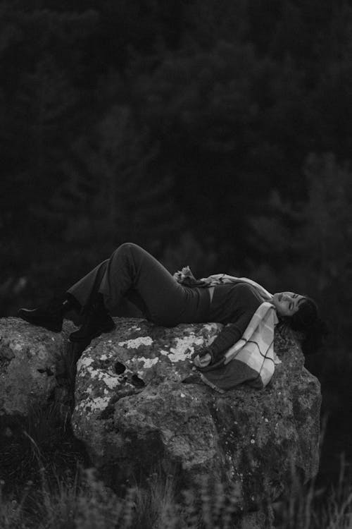 Woman Lying on Rocks