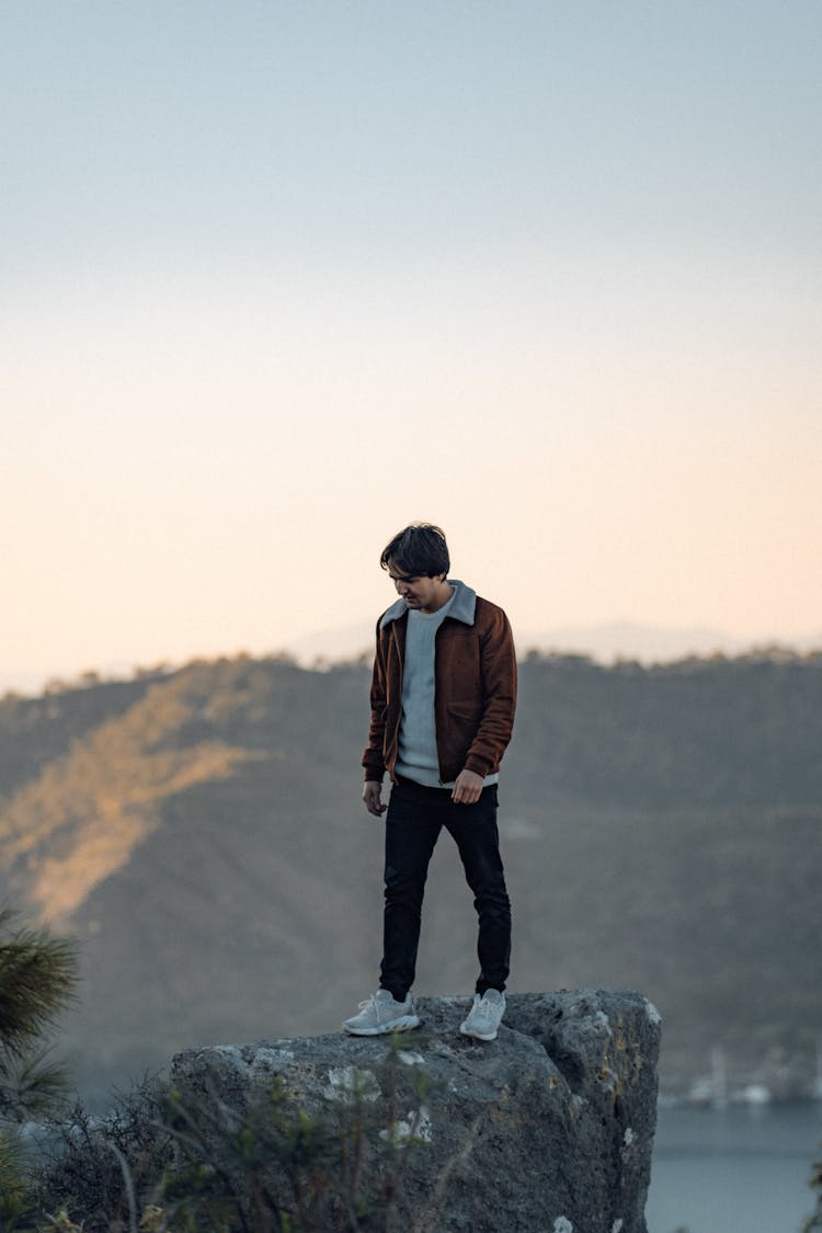 Man Standing On A Rock In The Mountains