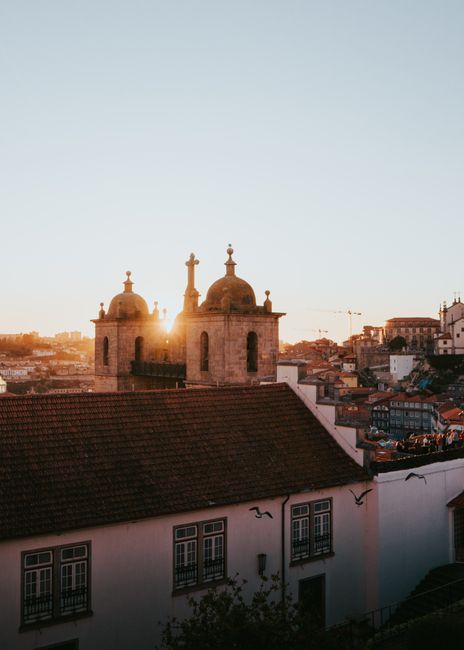 Breathtaking sunset view over Porto Cathedral in Portugal with charming rooftops and a vibrant sky.