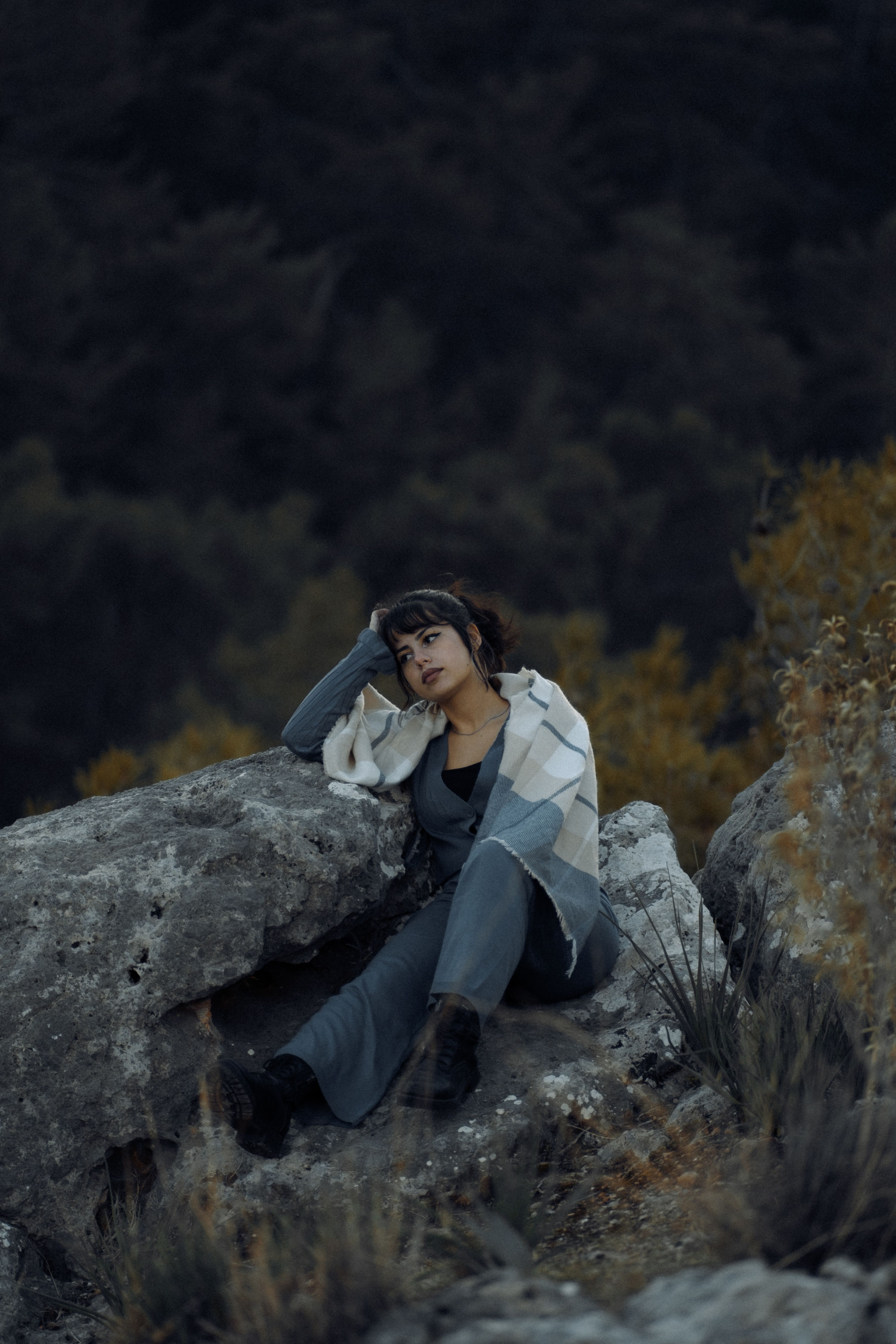 Woman Sitting and Posing on a Rock in the Mountains · Free Stock Photo