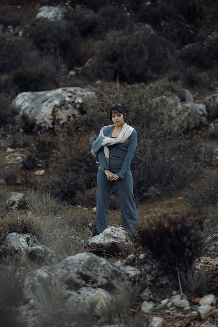 Woman Standing On Rocky Ground 