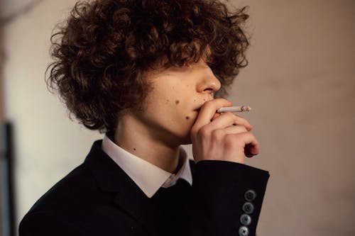 Young Man in Suit Smoking Cigarette