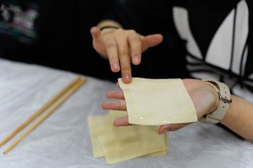 A Person Holding a Dumpling Wrapper