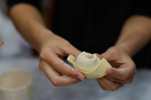 A Person Holding a Dumpling